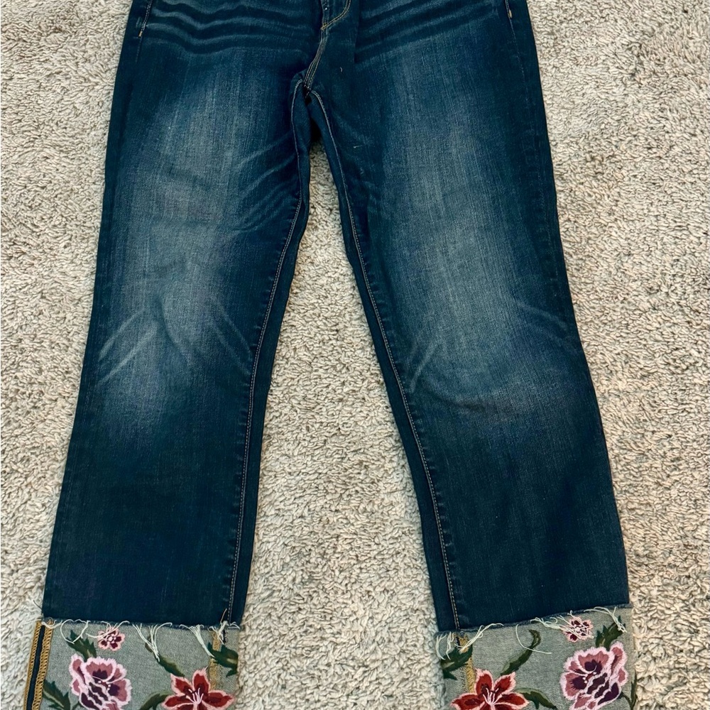 Driftwood jeans with floral embroidered cuffs.